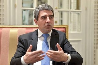 Bulgarian President Rosen Plevneliev, seated, gesturing as he speaks